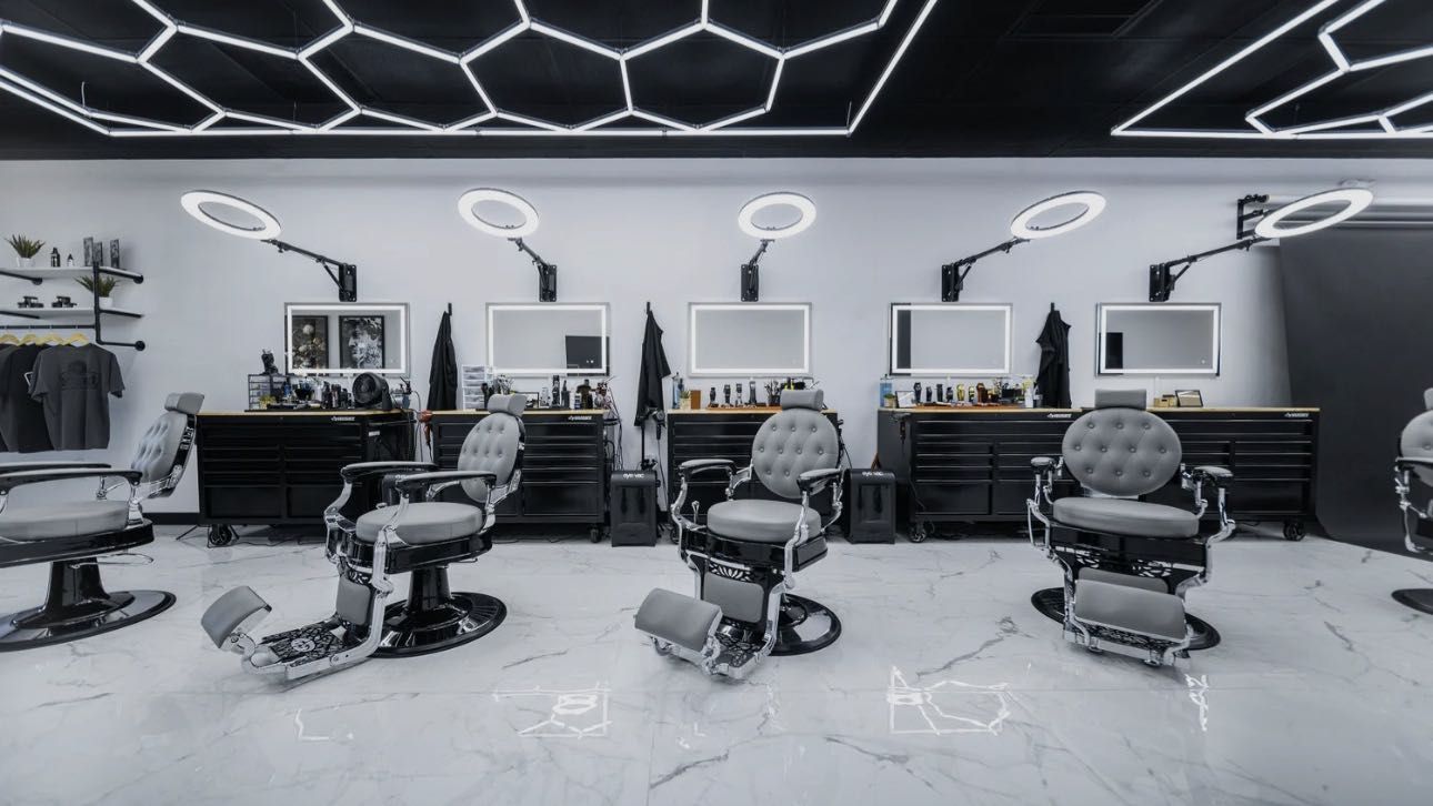 Inside Levy’s Barber Shop: chrome chairs, marble floor, honeycomb ceiling lights.